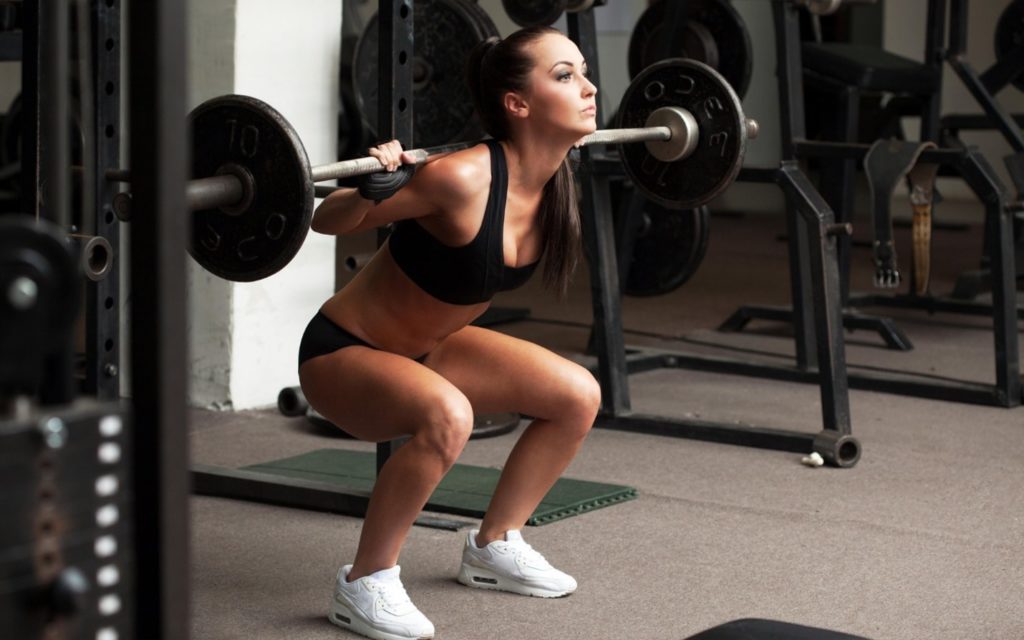 Woman Doing Squats With Dumbbells